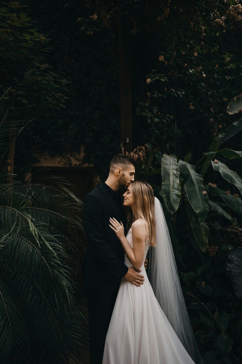 Bride and groom in a moody cinematic embrace